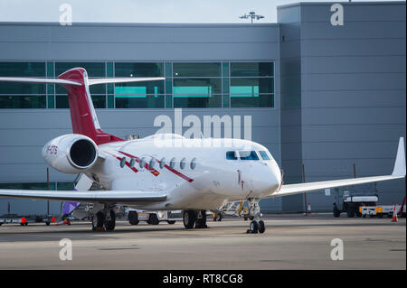 Gulfstream G650 twin-engine business jet airplane waiting on the apron area of Luton airport, England. Stock Photo