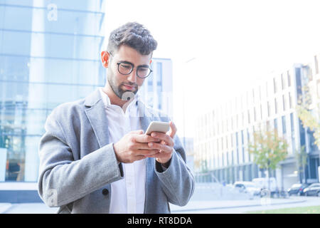 Portrait of young businessman using cell phone Stock Photo