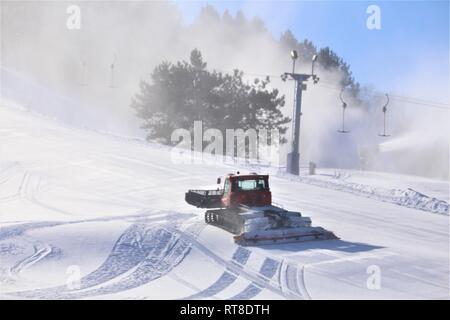 An employee operates a groomer on a hill Jan. 25, 2019, at Whitetail Ridge Ski Area at Fort McCoy, Wis. Whitetail Ridge, part of Fort McCoy’s Pine View Recreation Area, offers a variety of activities for the whole family. The ski hill offers both downhill skiing and snowboarding. Stock Photo