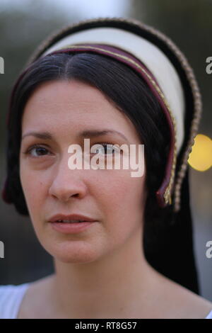 A beautiful but sad dark haired Tudor Woman in authentic Tudor dress looks in to camera- she is lady in waiting to Anne Boleyn Stock Photo