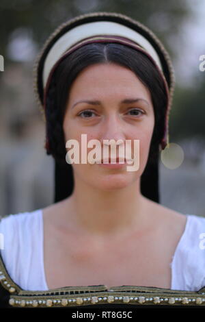 A beautiful but sad dark haired Tudor Woman in authentic Tudor dress looks in to camera- she is lady in waiting to Anne Boleyn Stock Photo