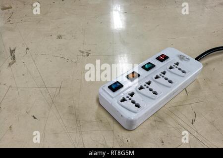 multiple socket plug. old movable electric plug with separate switch for each socket. Stock Photo