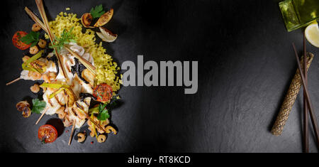 Flatfish Fillet with Shrimps on black Slate Stock Photo