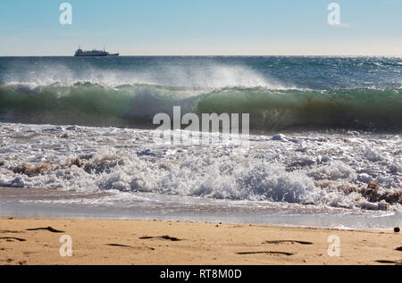 Palma de Mallorca - The big wave and the cargo in background. Stock Photo