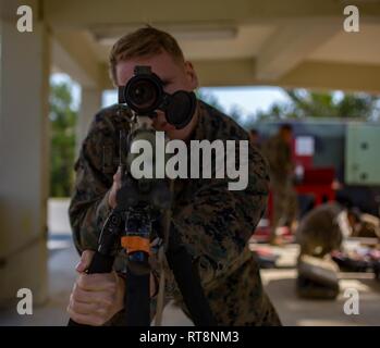 Petty Officer 3rd class Brandon Thieleman with 1st Battalion, 3rd Marines, currently attached to 3rd Marine Division, sights in with an M-40 on Camp Hansen, Okinawa, Japan, Jan. 29, 2019. The training is designed to improve the unit’s effectiveness with the rifle. Stock Photo