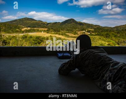 Lance Cpl. Devin Ford with 1st Battalion, 3rd Marines, currently attached to 3rd Marine Division, sights in with an M-40 on Camp Hansen, Okinawa, Japan, Jan. 29, 2019. The training is designed to improve the unit’s effectiveness with the rifle. Stock Photo