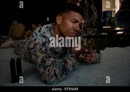 Lance Cpl. Devin Ford with 1st Battalion, 3rd Marines, currently attached to 3rd Marine Division, sights in with an M-40 on Camp Hansen, Okinawa, Japan, Jan. 29, 2019. The training is designed to improve the unit’s effectiveness with the rifle. Stock Photo