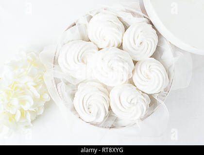 White tender marshmallow in a white box on a light background. Traditional holiday gift. Copy space. Stock Photo