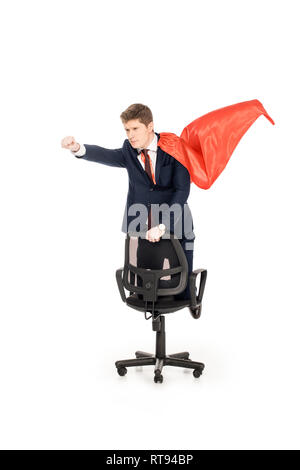 super businessman in red cloak riding chair isolated on white Stock Photo