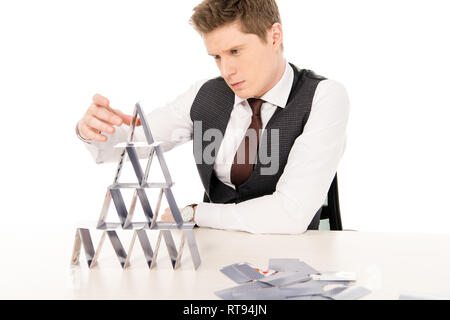 stylish man making pyramid from playing cards isolated on white Stock Photo