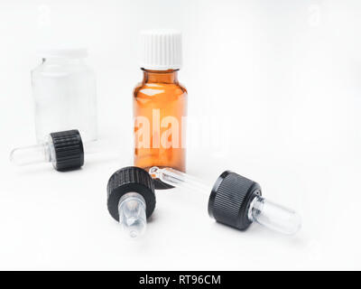 Brown and white medicine glass bottles with dropper isolated over white background, pipettes, Medical bank Stock Photo