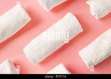 White spa towels on pink background, top view Stock Photo