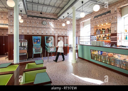 Retro-looking interiors and formica pastel furniture at Bar Luce, Wes Anderson-inspired bar and cafe in the Fondazione Prada district of Milan, Italy Stock Photo
