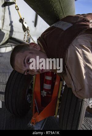 MEDITERRANEAN SEA, Jan. 30, 2019 – U.S. Marine Lance Cpl. Derek Thale, an UH-1Y crew chief with the 22nd Marine Expeditionary Unit, attaches a toe wheel to the skid of an UH-1Y Huey utility helicopter on the flight deck of the San Antonio-class amphibious transport dock ship USS Arlington (LPD 24), Jan. 30, 2019. The USS Arlington is making a scheduled deployment as part of the 22nd MEU and the Kearsarge Amphibious Ready Group, in support of maritime security operations, crisis response and theatre security cooperation, while also providing a forward Naval and Marine presence. Stock Photo