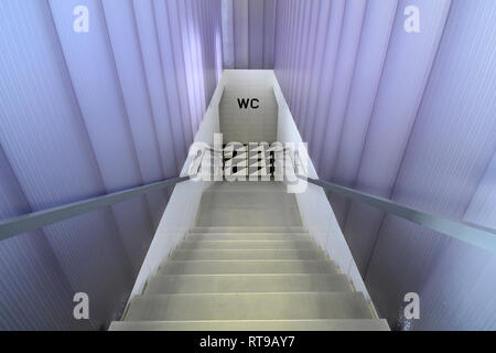 The staircase leading to the bathroom of Bar Luce, Wes Anderson-inspired bar and cafe in the Fondazione Prada district of Milan, Italy Stock Photo