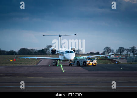 Small private jet airplane towing in international airport Stock Photo ...