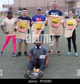 U.S. Army Soldiers assigned to the 335th Signal Command (Theater) (Provisional) pose after completing the Camp Arifjan Half Marathon at Camp Arifjan, Kuwait, January 27, 2019. Front row: Sgt. Rodney Pina. Back row (from left to right): Sgt. 1st Class Carmen Granville, 1st Lt. Phuong Tran, Sgt. 1st Class Kristopher Davis, Sgt. 1st Class David Moseley, Capt. Asia Hernandez-Carr. Stock Photo