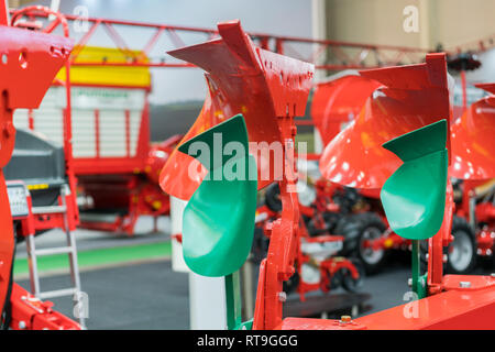 Corn harvester head with several silver blades. Agricultural machinery for soil cultivation. Stock Photo