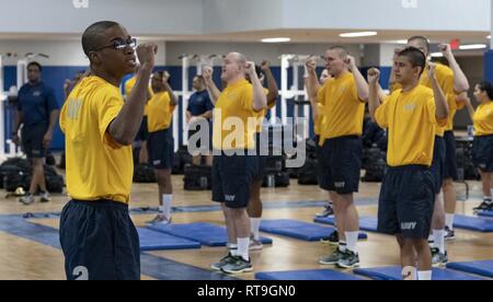 GREAT LAKES Ill. Jan. 29 2019 Recruits perform a warm up exercise during a physical training session inside Freedom Hall at Recruit Training Command. More than 30 000 recruits graduate annually from t...