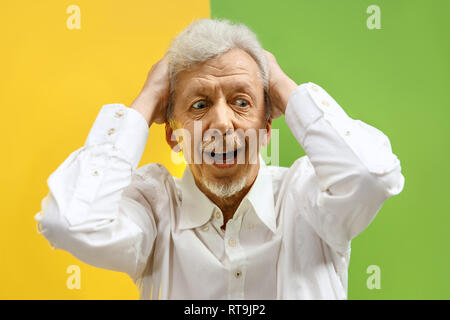Wow. The senior male portrait on color studio backgroud. emotional surprised bearded man standing with open mouth. Human emotions, facial expression concept. Trendy colors Stock Photo