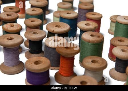 wooden coils with colorful threads of pastel colors Stock Photo