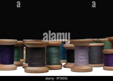wooden coils with colorful threads of pastel colors Stock Photo