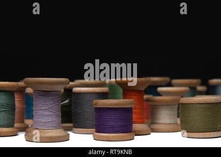 wooden coils with colorful threads of pastel colors Stock Photo