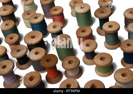 wooden coils with colorful threads of pastel colors Stock Photo