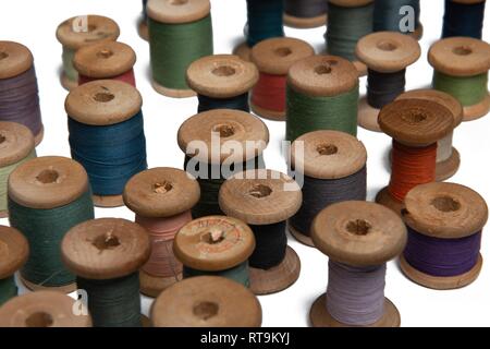 wooden coils with colorful threads of pastel colors Stock Photo