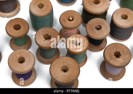 wooden coils with colorful threads of pastel colors Stock Photo