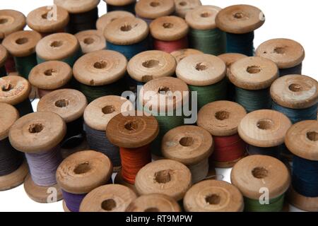 wooden coils with colorful threads of pastel colors Stock Photo