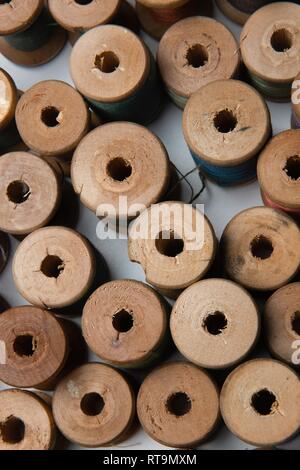 wooden coils with colorful threads of pastel colors Stock Photo