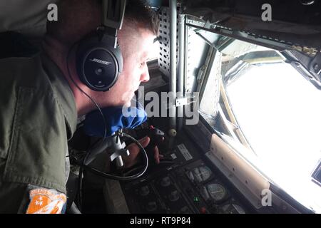 U.S. Air Force Tech. Sgt. Andrew Weber, a boom operator with the Tennessee Air National Guard's 134th Air Refueling Wing, operates a boom during an air-to-air refueling mission media flight with a KC-135 Stratotanker from the 134th Air Refueling Wing, Tennessee Air National Guard and an F-16 Fighting Falcon from the South Carolina Air National Guard's 169th Fighter Wing, Jan. 29, 2019. Stock Photo