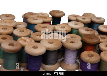 wooden coils with colorful threads of pastel colors Stock Photo