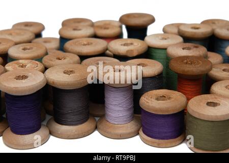 wooden coils with colorful threads of pastel colors Stock Photo