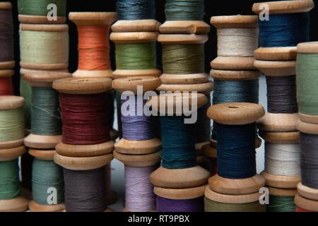 wooden coils with colorful threads of pastel colors Stock Photo