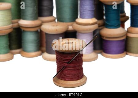 wooden coils with colorful threads of pastel colors Stock Photo