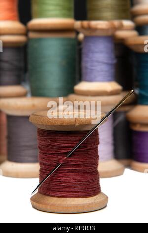 wooden coils with colorful threads of pastel colors Stock Photo