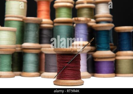 wooden coils with colorful threads of pastel colors Stock Photo