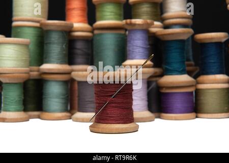 wooden coils with colorful threads of pastel colors Stock Photo