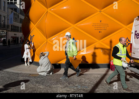 Friends greet each other opposite the temporary renovation hoarding of  luxury brand Louis Vuitton in New Bond Street, on 25th February 2019, in  London, England Stock Photo - Alamy