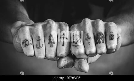 Close up of tattoos on fingers and knuckles. Black and white hand tattoo  concept Stock Photo - Alamy