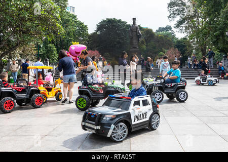 Children playing in electric cars in a public space near to the Hanoi Children's Palace, Hanoi Old Quarter, Hanoi, Vietnam, Asia Stock Photo