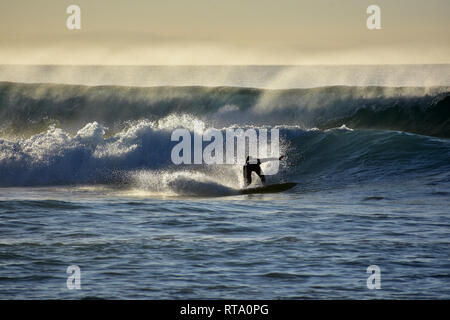 Surfers on the atlantic ocean waves in la pared on fuerteventura canary islands in spain Stock Photo