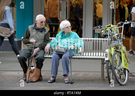 Elderly couple sitting on a bench, Nottingham. Stock Photo