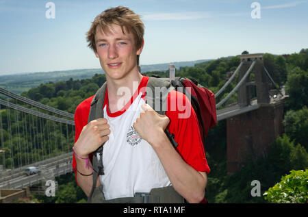 A travelling student, photographed with the Clifton Suspension Bridge, Bristol, UK Stock Photo