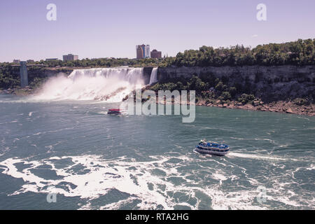 NIAGARA FALLS, ONTARIO, CANADA - JUNE 25, 2018: American Falls and american side in the background. The famous Maid Of the Mist and Hornblower tour bo Stock Photo