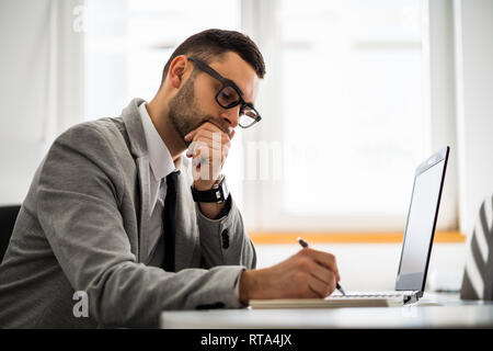Young businessman is working in office. Stock Photo