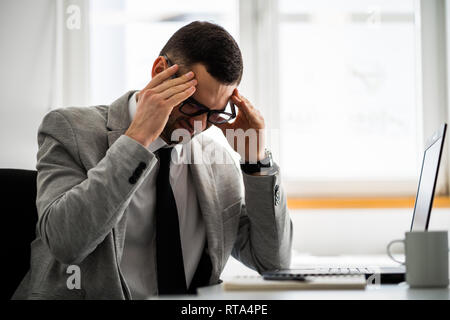 Young businessman is having headache. Stock Photo