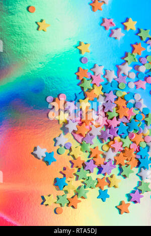 Holographic paper with colorful candy stars and dots Stock Photo